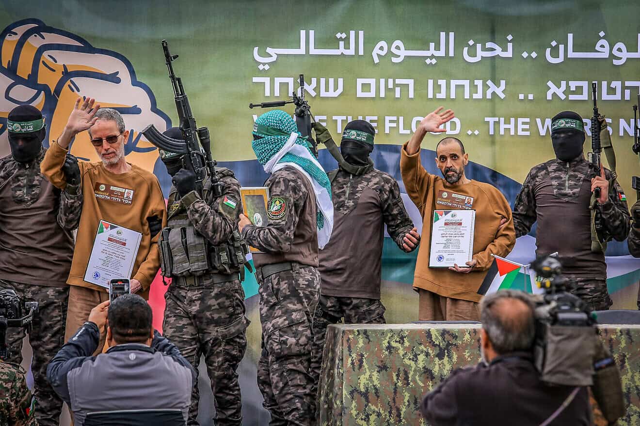 Hamas terrorists parade Israeli hostages Eli Sharabi (right), Or Levy and Ohad Ben Ami (left) on a stage before handing them over to the International Red Cross, Feb 8, 2025. Photo by Abed Rahim Khatib/Flash90.