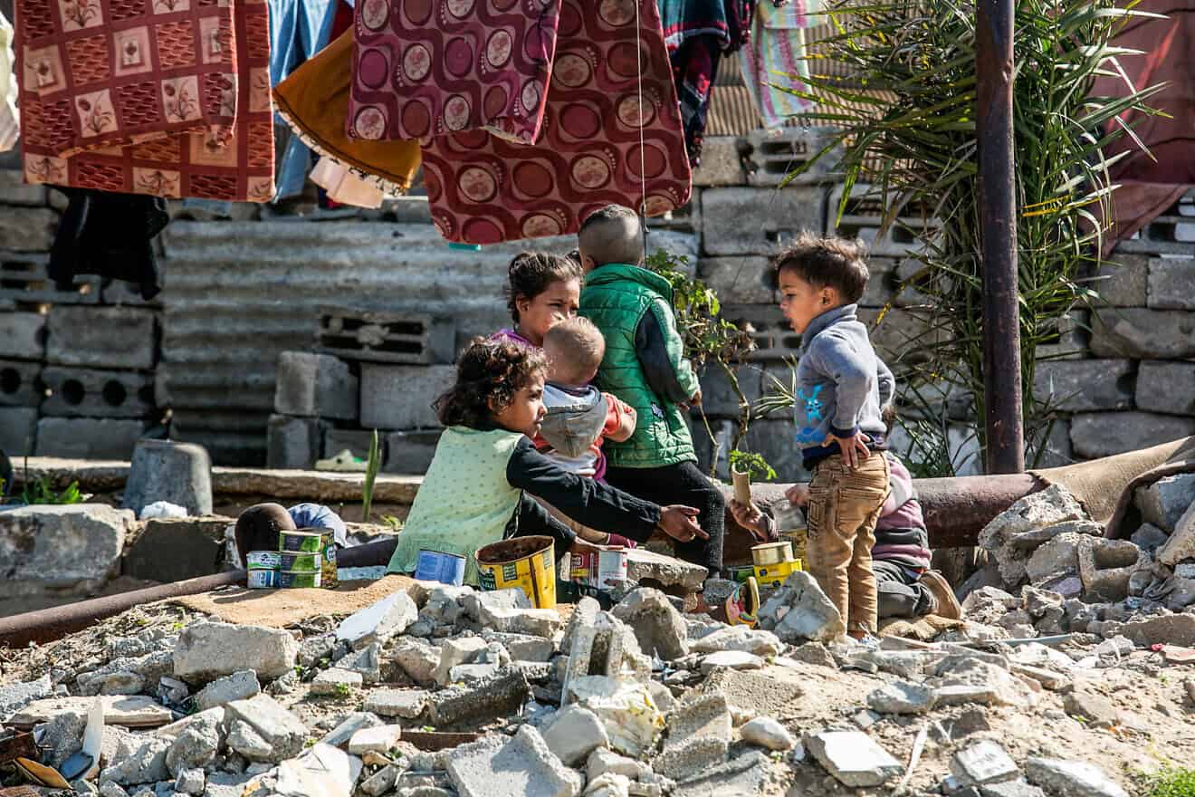 Palestinians near destroyed homes in Khan Yunis in the southern Gaza Strip on Feb. 16, 2025. Photo by Abed Rahim Khatib/Flash90.