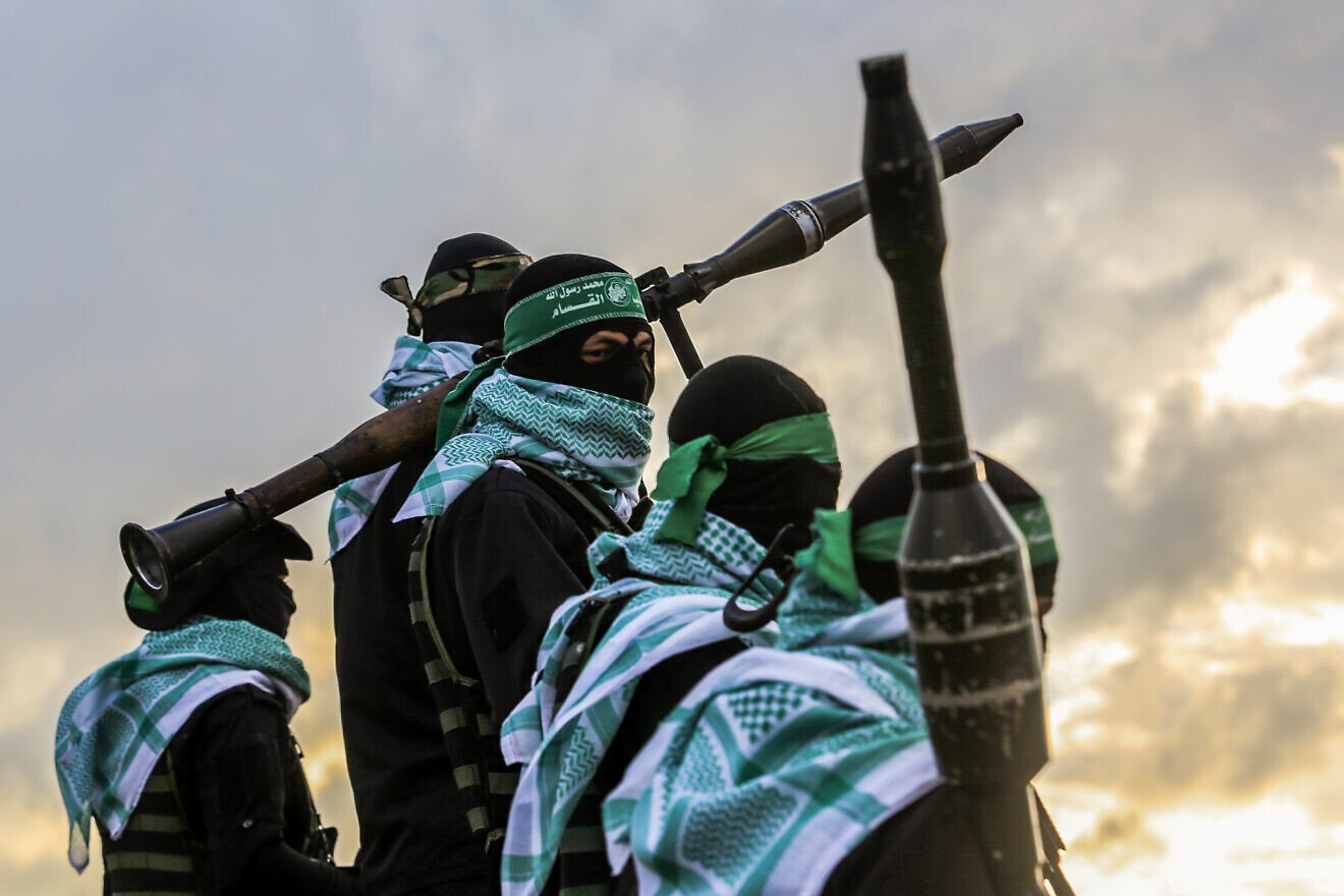 Hamas terrorists amid a transfer of four bodies of Israeli hostages, whom Hamas murdered, to Israel, Gaza, Feb. 20, 2025. Credit: Abed Rahim Khatib/Flash90.