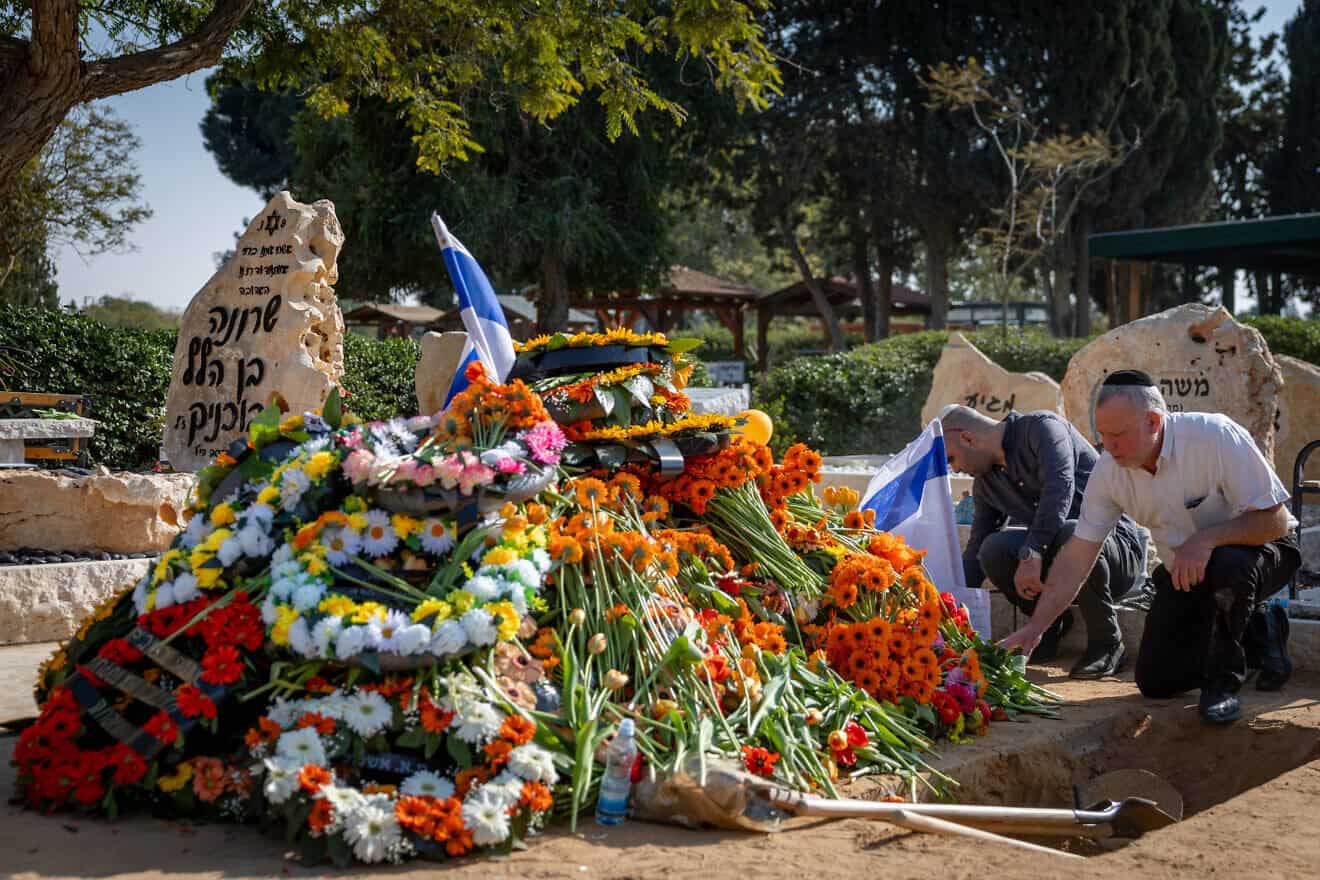 Mourners near the grave of Israeli hostages Shiri Bibas, and her young sons Ariel and Kfir, at the cemetery in Tzohar in southern Israel, on Feb. 26, 2025. Photo by Chaim Goldberg/Flash90.