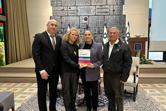 Jewish Agency CEO Yehuda Setton (left); Jewish Agency’s Fund for the Victims of Terror chair Ayelet Nahmias-Verbin; and Jewish Agency chairman Maj. Gen. (res.) Doron Almog present the report to first lade Michal Herzog (second from right), Feb. 17, 2025. Credit: Courtesy.