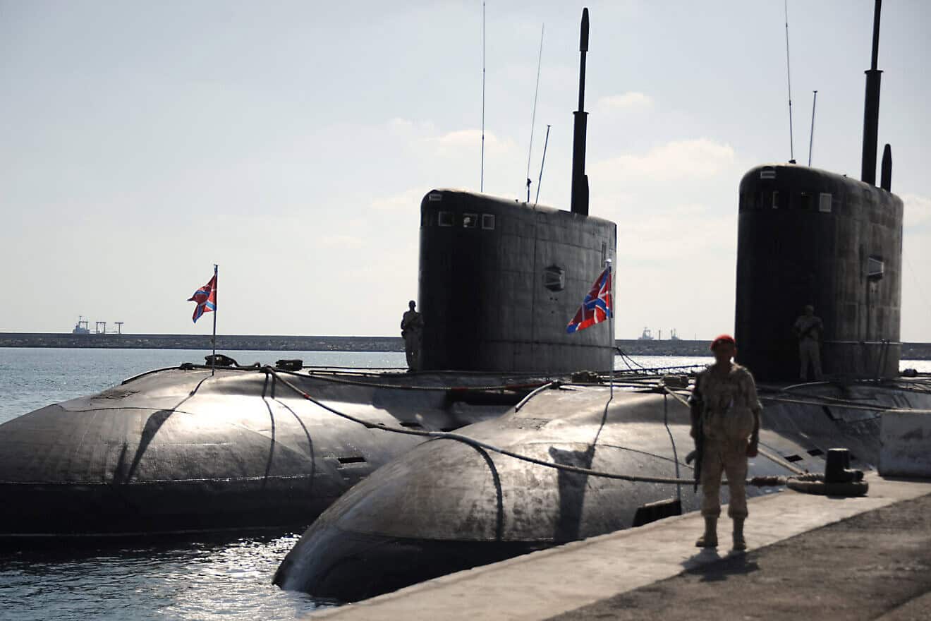 A Russian soldier stands next to submarines at the Russian naval base in the Syrian Mediterranean port of Tartus on Sept. 26, 2019. Photo by Maxime Popov/AFP via Getty Images.
