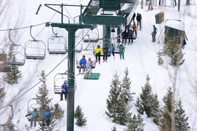 Skiers ride a lift at Deer Valley Ski Resort in Park City, Utah, on Dec. 23, 2022. Photo by George Frey/AFP via Getty Images.