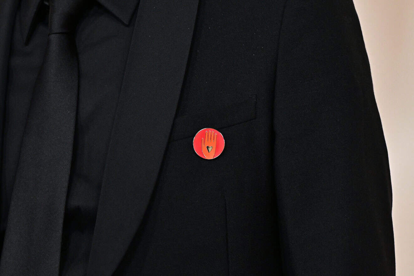 FIlm producer Nadim Cheikhrouha wears an "Artists4Ceasefire" pin, calling for de-escalation and ceasefire in Gaza and Israel, as he attends the 96th Annual Academy Awards at the Dolby Theatre in Hollywood, California on March 10, 2024. Photo by Frederic J. Brown/AFP via Getty  Images.