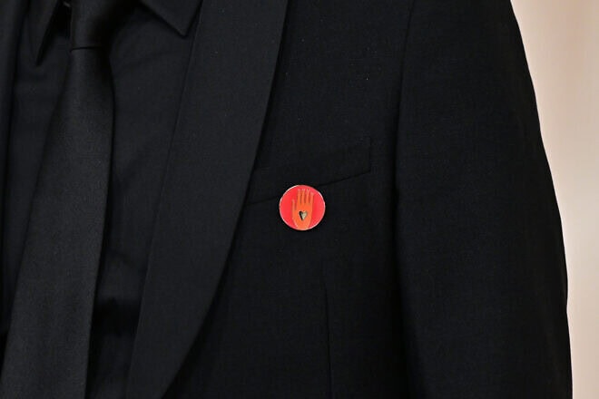 FIlm producer Nadim Cheikhrouha wears an "Artists4Ceasefire" pin, calling for de-escalation and ceasefire in Gaza and Israel, as he attends the 96th Annual Academy Awards at the Dolby Theatre in Hollywood, California on March 10, 2024. Photo by Frederic J. Brown/AFP via Getty  Images.