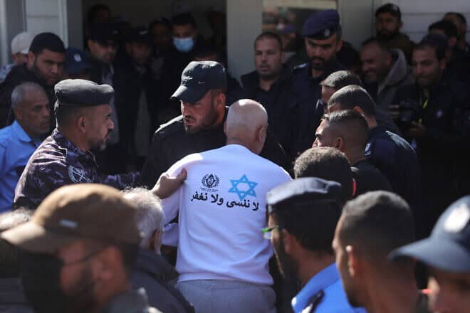 A former Palestinian prisoner, released as part of the sixth hostage-prisoner exchange and wearing a sweatshirt featuring the prison service logo, a Star of David, and the slogan: "We do not forget and we do not forgive", is helped by Palestinian security forces upon arriving at the European Hospital in Khan Yunis in the southern Gaza Strip on Feb. 15, 2025. Photo by Bashar Taleb/AFP via Getty Images.