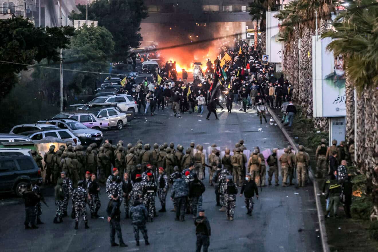 Hezbollah supporters burn tires in front of Lebanese Army soldiers during a Hezbollah-organized rally to block the road to Beirut International Airport, in Beirut, Lebanon, Febr. 15, 2025. Photo by Ibrahim Amro/AFP via Getty Images.