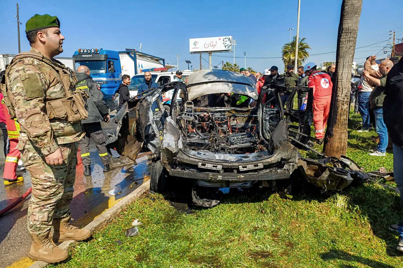 Lebanese army, security forces and civil-defense first responders inspect the remains of a destroyed vehicle that was reportedly hit by an Israeli airstrike in Lebanon's southern city of Sidon, Feb. 17, 2025. Photo by AFP via Getty Images.