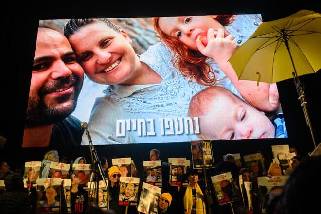 A photo of Yarden Bibas, Shiri Bibas, Ariel Bibas and Kfir Bibas are shown on the screen during the weekly rally calling on the continuation of the ceasefire and hostage agreement in Hostage Square on Feb. 22, 2025 in Tel Aviv, Israel. Photo by Alexi J. Rosenfeld/Getty Images.