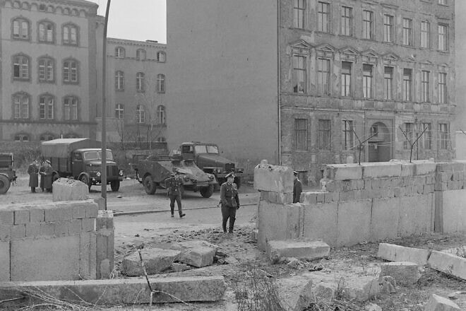East German guards look at the hole in the anti-refugee wall where two people broke through and escaped to West Berlin. April 9, 1962. Credit: Getty Images.