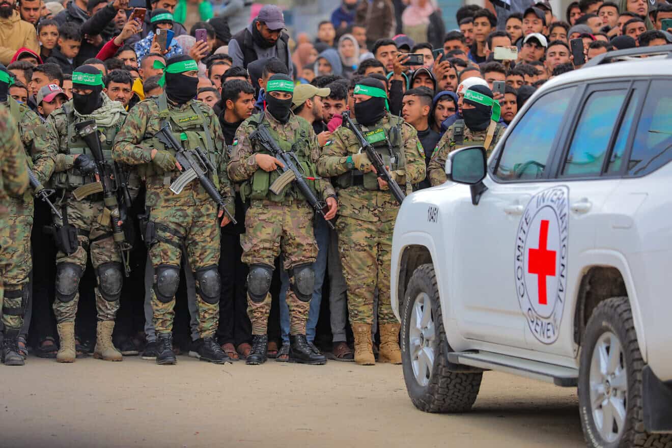 Hamas terrorists hand over three male Israeli hostages to the Red Cross, as part of the ceasefire agreement between Jerusalem and the Islamist group, in Deir al-Balah, the Gaza Strip, on Feb. 8, 2025. Photo by Ali Hassan/Flash90.