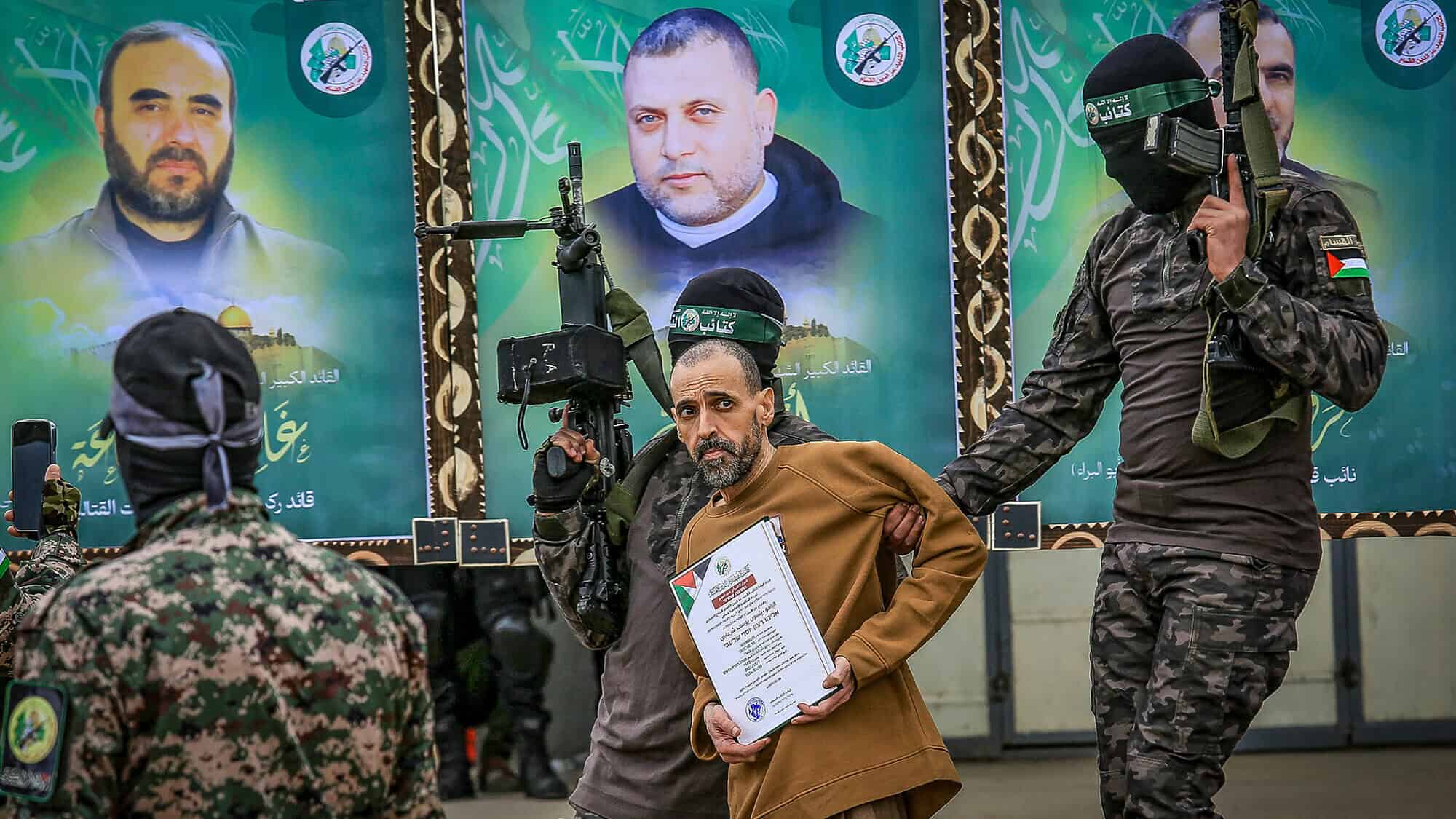 Hamas's Al-Qassam Brigades parade Israeli captive Eli Sharabi in Deir al-Balah, the Gaza Strip, before handing him over to the International Red Cross, Feb 8, 2025. Photo by Abed Rahim Khatib/Flash90.