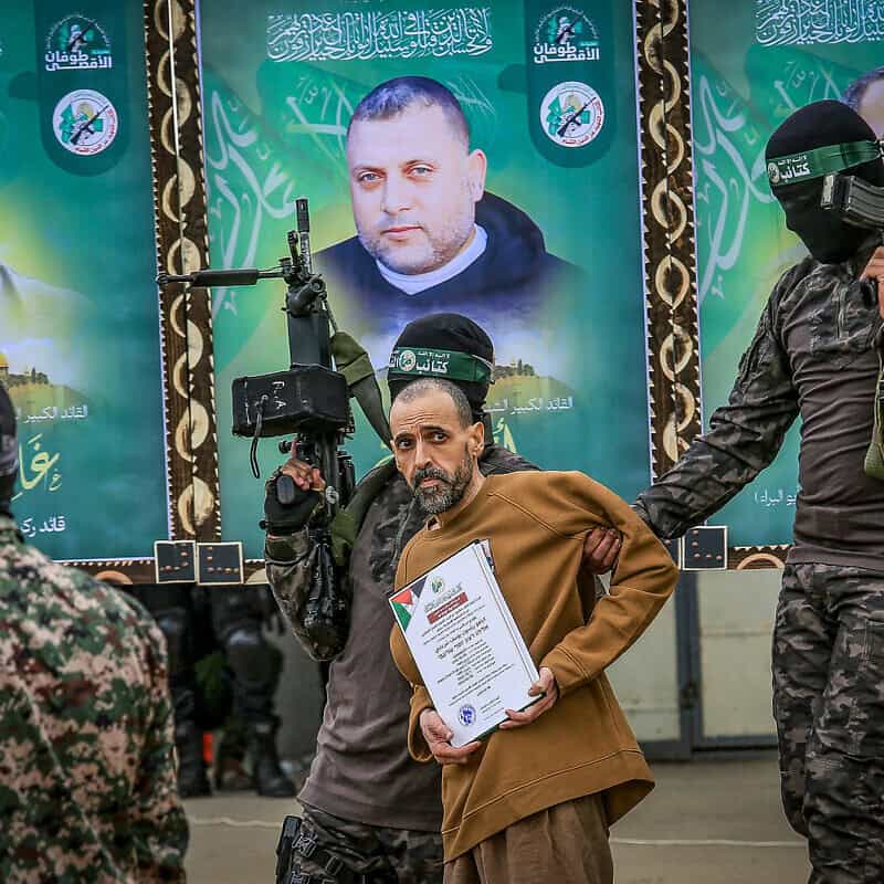 Hamas's Al-Qassam Brigades parade Israeli captive Eli Sharabi in Deir al-Balah, the Gaza Strip, before handing him over to the International Red Cross, Feb 8, 2025. Photo by Abed Rahim Khatib/Flash90.