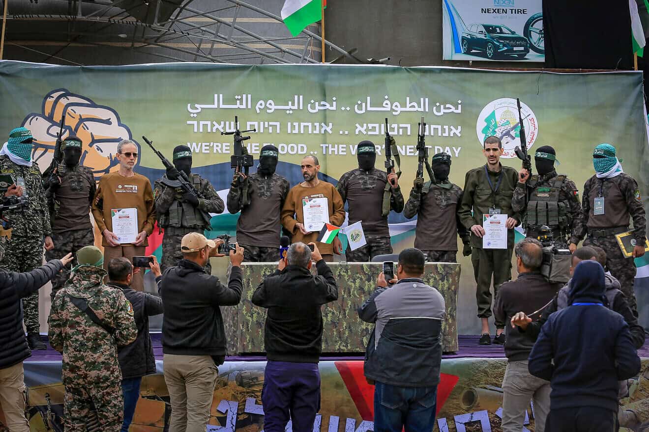 Hamas terrorists in its Al-Qassam Brigades parade Israeli hostages Eli Sharabi (right), Or Levy and Ohad Ben Ami (left) on a stage before handing them over to the International Red Cross, Feb 8, 2025. Photo by Abed Rahim Khatib/Flash90.