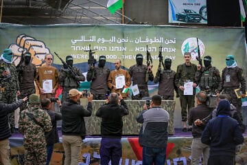 Hamas's Al-Qassam Brigades terrorists parade Israeli hostages Eli Sharabi (right), Or Levy and Ohad Ben Ami (left) on a stage before handing them over to the International Red Cross, on Feb 8, 2025. Photo by Abed Rahim Khatib/Flash90.