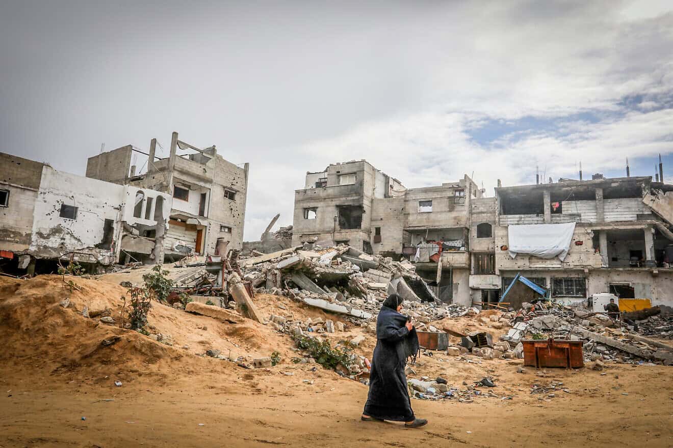 A Palestinian woman walks among wreckage in the city of Khan Yunis in the southern Gaza Strip. Photo by Abed Rahim Khatib/Flash90.