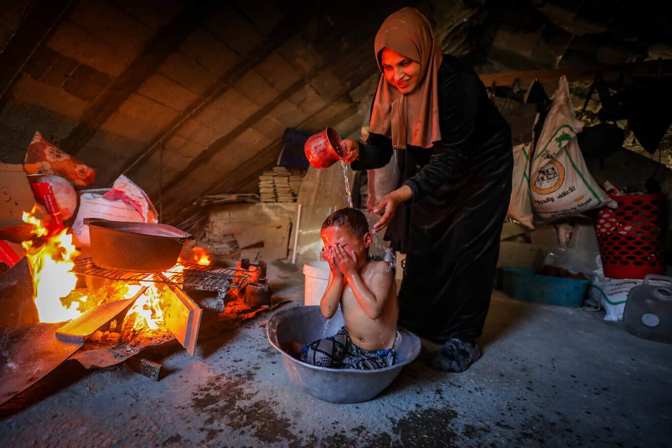 A Palestinian mother and child in Beit Lahia, in the central Gaza Strip, on Feb. 23, 2025. Photo by Ali Hassan/Flash90.