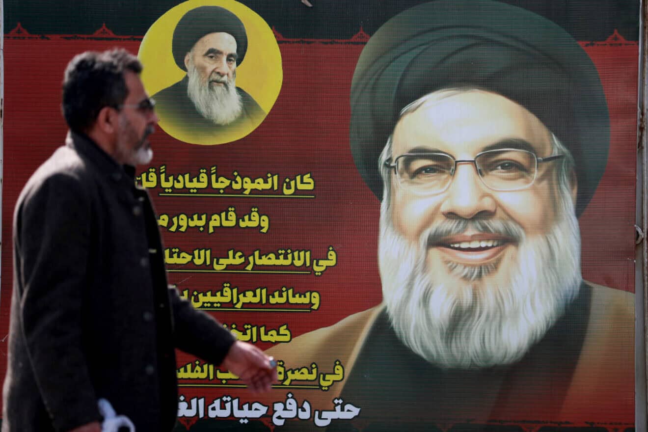 A man walks past a portrait of slain Hezbollah leader Hassan Nasrallah on a main road in Baghdad on Feb. 19, 2025. Photo by Ahmad al-Rubaye/AFP via Getty Images.