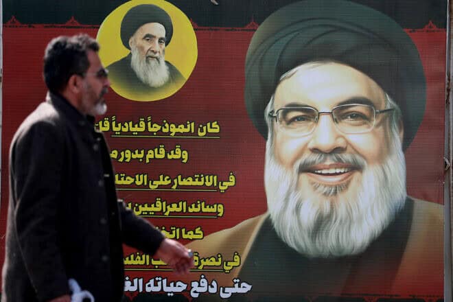 A man walks past a portrait of slain Hezbollah leader Hassan Nasrallah on a main road in Baghdad on Feb. 19, 2025. Photo by Ahmad al-Rubaye/AFP via Getty Images.