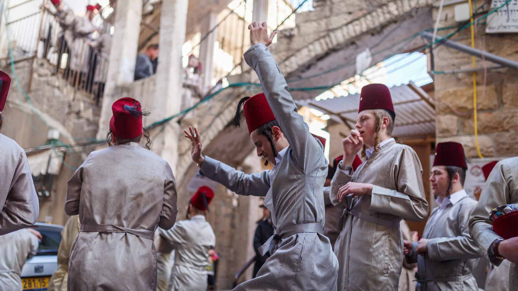 Religious Jewish youth in the Jerusalem neighborhood of Mea She'arim celebrate the holiday of Purim. Photo by Emily Glick/Middle East Images/Middle East Images/AFP via Getty Images.