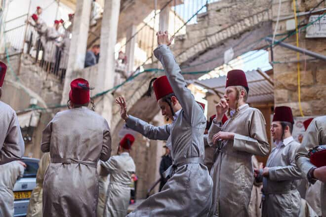 Religious Jewish youth in the Jerusalem neighborhood of Mea She'arim celebrate the holiday of Purim. Photo by Emily Glick/Middle East Images/Middle East Images/AFP via Getty Images.