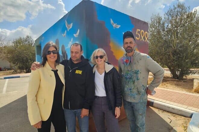 (From left) Talia Tzour Avner, CIO of Jewish National Fund-USA, Nissan Calderon, brother of released hostage Ofer Calderon, Deborah Lust Zaluda, and Aliyasaf Meira, an artist who paints bomb shelters, stand in front of a bomb shelter at Kibbutz Magen dedicated on the 500th day of the war. Photo: JNF-USA