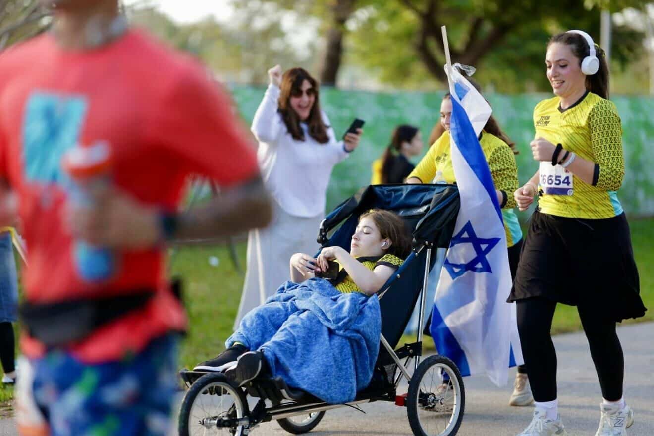 Members of Team Lifeline get some cheer as they race in the Miami Marathon. Credit: Courtesy of Chai Lifeline.