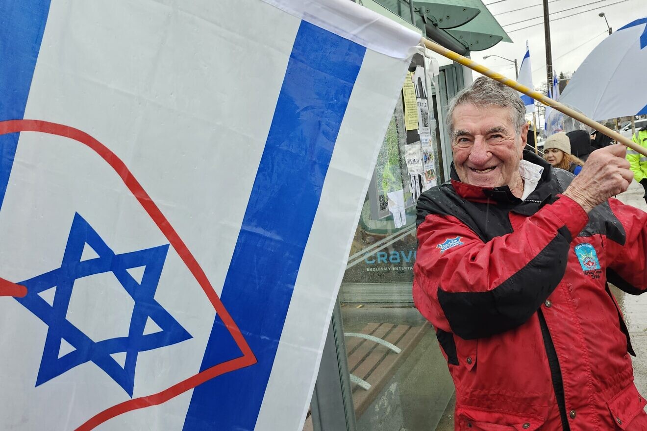 Joel Sacke, 88, holds an Israeli flag with a red heart at a rally in Toronto, March 16, 2025. Photo by Dave Gordon.