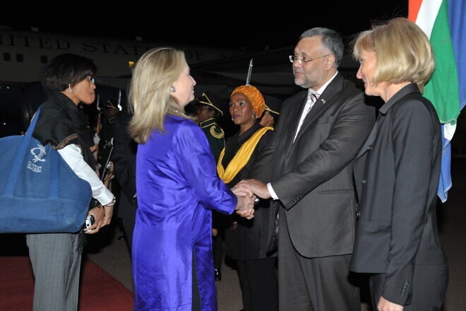 U.S. Secretary of State Hillary Rodham Clinton is greeted by South African Ambassador to the United States Ebrahim Rasool upon her arrival to Johannesburg, South Africa, Aug. 6, 2012. Credit: U.S. State Department/public domain.