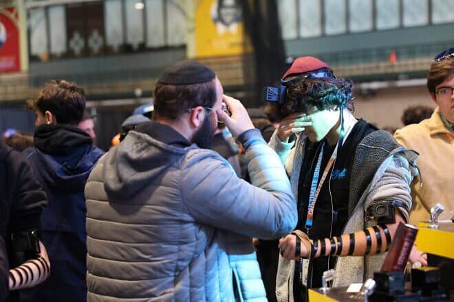 Attendees of the annual CTeen Shabbaton in Brooklyn, N.Y., participate in an effort to break the world record for putting on tefillin, Feb. 28, 2025. Photo by Shalom Ross/Merkos 302.