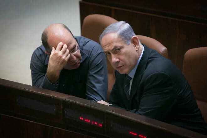 Israeli Prime Minister Benjamin Netanyahu speaks with Defense Minister Moshe Ya'alon in the plenary hall of the Knesset, the Israeli parliament in Jerusalem, May 11, 2015. Photo by Miriam Alster/Flash90.