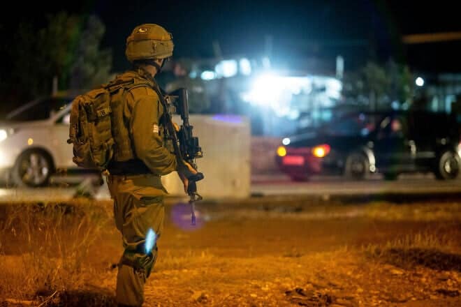 Israeli troops stand near the scene of a suspected car-ramming attack at the entrance to the village of Husan in Judea, June 23, 2018. Photo by Aharon Krohn/Flash90.
