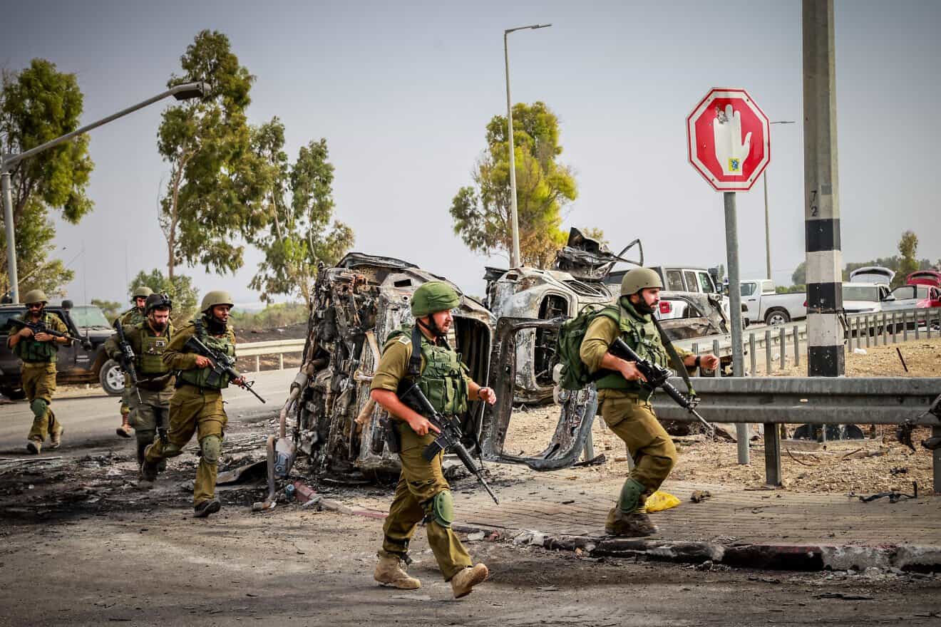 Israeli military personnel are seen near the entrance to Kibbutz Be'eri on Oct. 9, 2023. Photo by Yossi Zamir/Flash90.