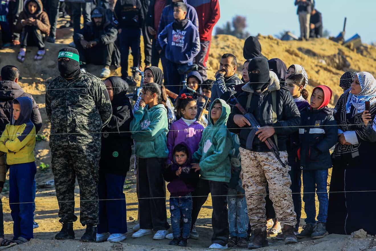 Palestinian women and children in Gaza joined members of the Al-Qassam Brigades to watch Israeli hostages being handed over to the Red Cross on Feb. 15, 2025. Photo by Abed Rahim Khatib/Flash90.