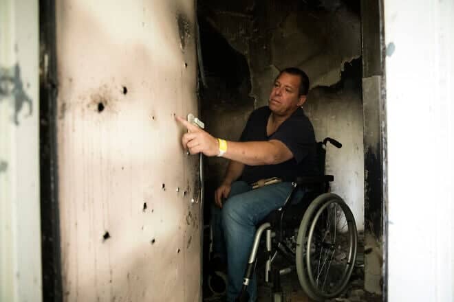 Avida Bachar inspects bullet holes in the bomb shelter of his Kibbutz Be'eri home, Jan. 8, 2024. Photo by Amir Levy/Getty Images.