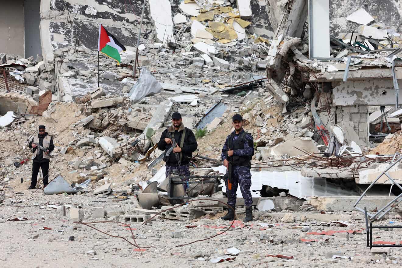 Members of Palestinian security forces loyal to Hamas stand guard in front of a destroyed police compound in Gaza City on the fourth day of a ceasefire deal in the war between Israel and Hamas in the Gaza Strip, on Jan. 22, 2025. Photo by Omar al-Qattaa/AFP via Getty Images.