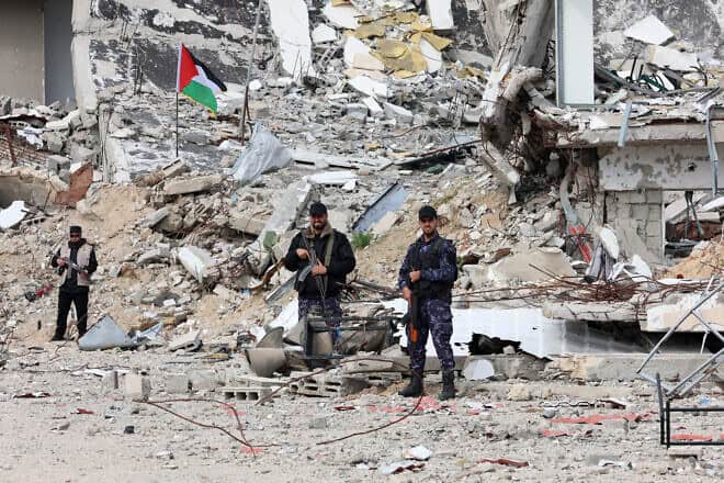 Members of Palestinian security forces loyal to Hamas stand guard in front of a destroyed police compound in Gaza City on the fourth day of a ceasefire deal in the war between Israel and Hamas in the Gaza Strip, on Jan. 22, 2025. Photo by Omar al-Qattaa/AFP via Getty Images.
