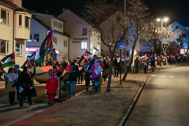 Demonstrators march with the Palestinian flag and torches prior to the UEFA Europa League Group football match between Bodoe/Glimt and Maccabi Tel Aviv in Bodoe, on January 23, 2025. Photo by Lise Åserud/NTB/AFP via Getty Images.