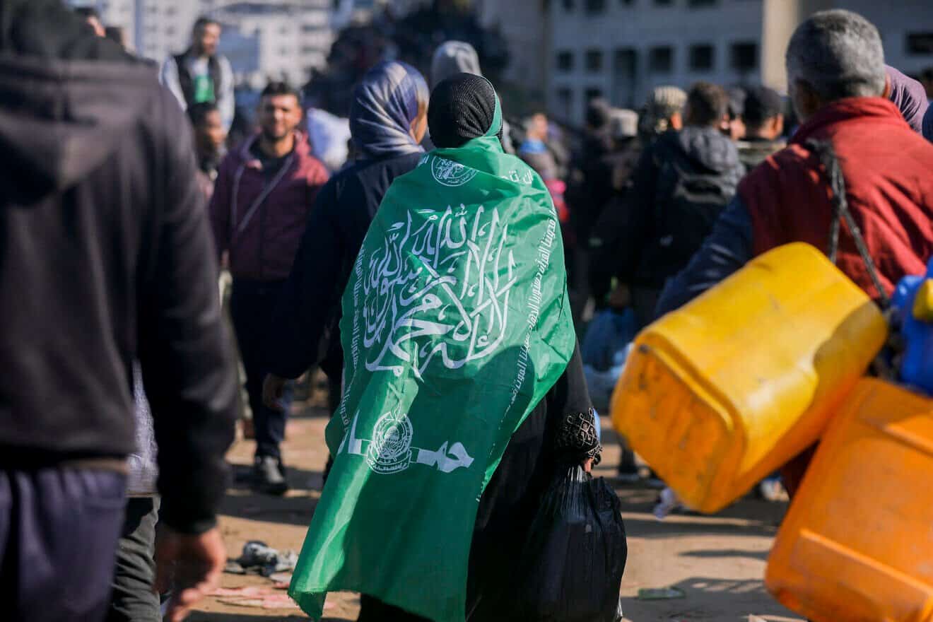 A Hamas terrorists walks along Gaza's Al-Rashid Street to cross the Netzarim Corridor from the southern Gaza Strip to the north, Jan. 27, 2025. Photo by Youssef Alzanoun/Middle East Images/AFP via Getty Images.