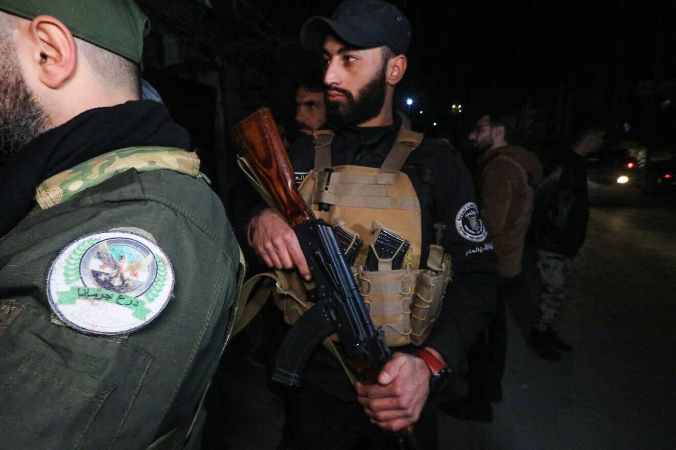 Members of Syria's new authorities security forces at a checkpoint as they deploy in the Druze and Christian majority Jaramana suburb of Damascus on March 2, 2025. Photo by Bakr Alkasem/AFP via Getty Images.