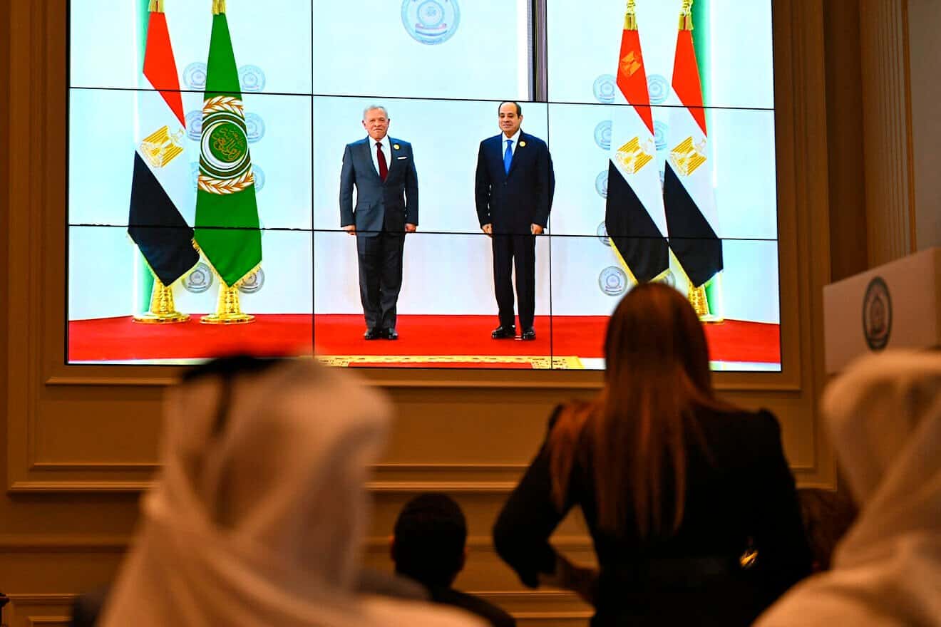 People watch on a big screen as Egyptian President Abdel Fattah el-Sisi (right) welcomes Jordan's King Abdullah II ahead of an Arab League summit on Gaza on March 4, 2025. Photo by Khaled Desouki/AFP via Getty Images.