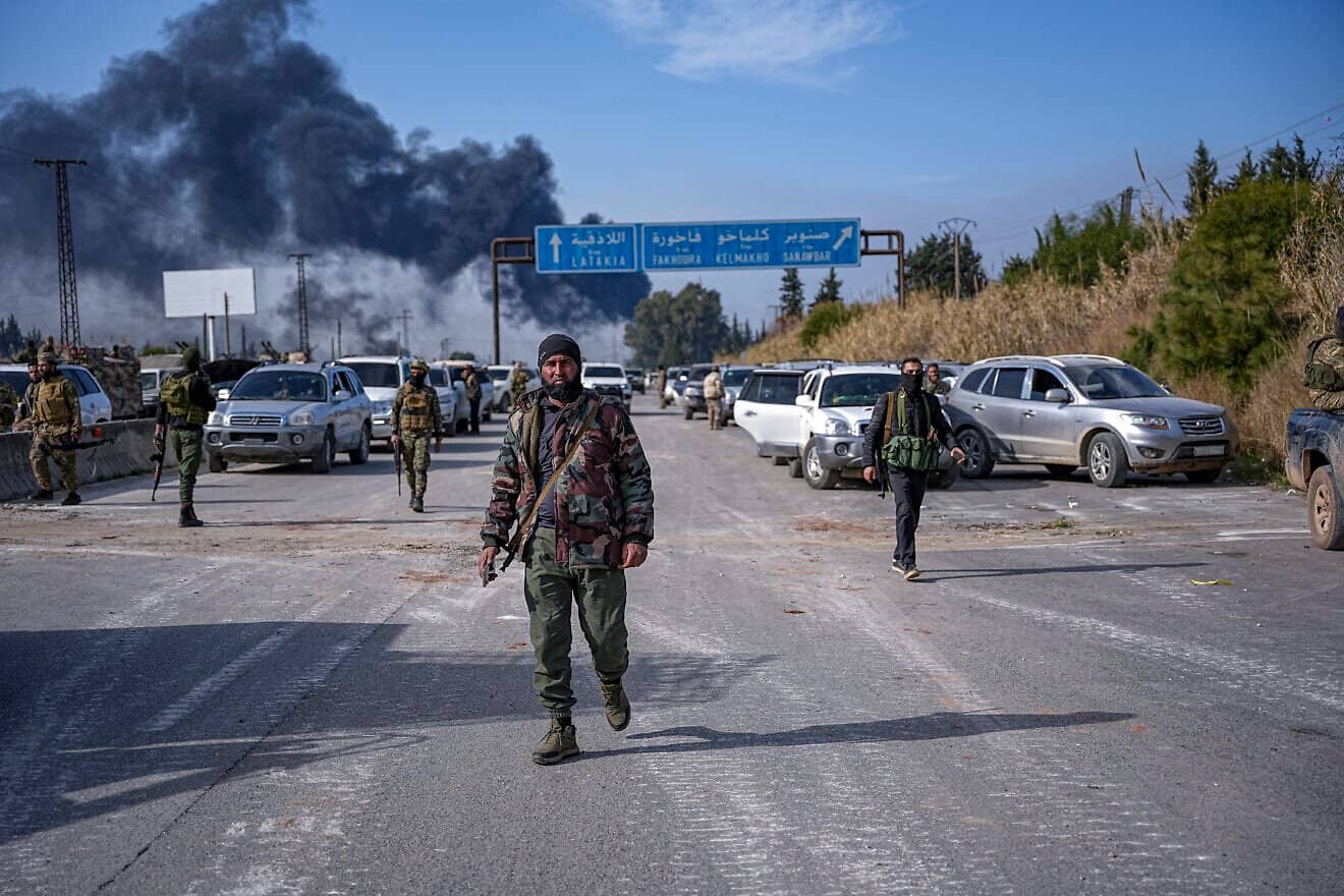 Forces of the new Syrian government's defense ministry and gunmen loyal to former President Bashar Assad battle on outskirts of Jableh in the Latakia countryside, on March 7, 2025. Photo by Mohamad Daboul/Middle East Images/AFP via Getty Images.