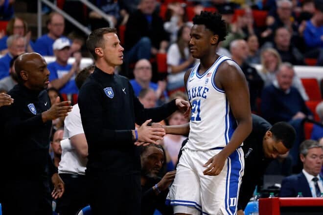 Head coach Jon Scheyer high-fives Patrick Ngongba II #21 of the Duke Blue Devils against the Mount St. Mary's Mountaineers in the second half during a first round game of the men's NCAA basketball tournament at Lenovo Center on March 21, 2025 in Raleigh, North Carolina. Photo by Lance King/Getty Images.