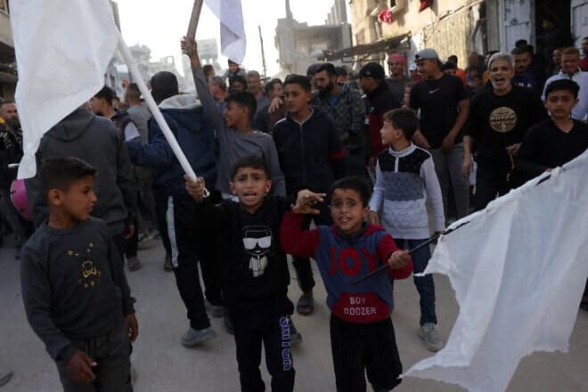 Palestinian children wave white flags during an anti-Hamas protest, calling for an end to the war with Israel, in Beit Lahia in the northern Gaza Strip on March 26, 2025. Photo by AFP via Getty Images.
