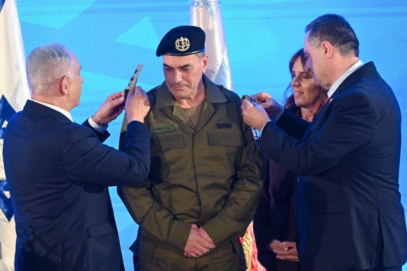 Prime Minister Benjamin Netanyahu and Defense Minister Israel Katz place the insignia of rank of a lieutenant general on incoming IDF chief of staff Eyal Zamir as his wife, Orna, watches, at IDF headquarters in Tel Aviv. March 5, 2025. Photo by Kobi Gideon/GPO.