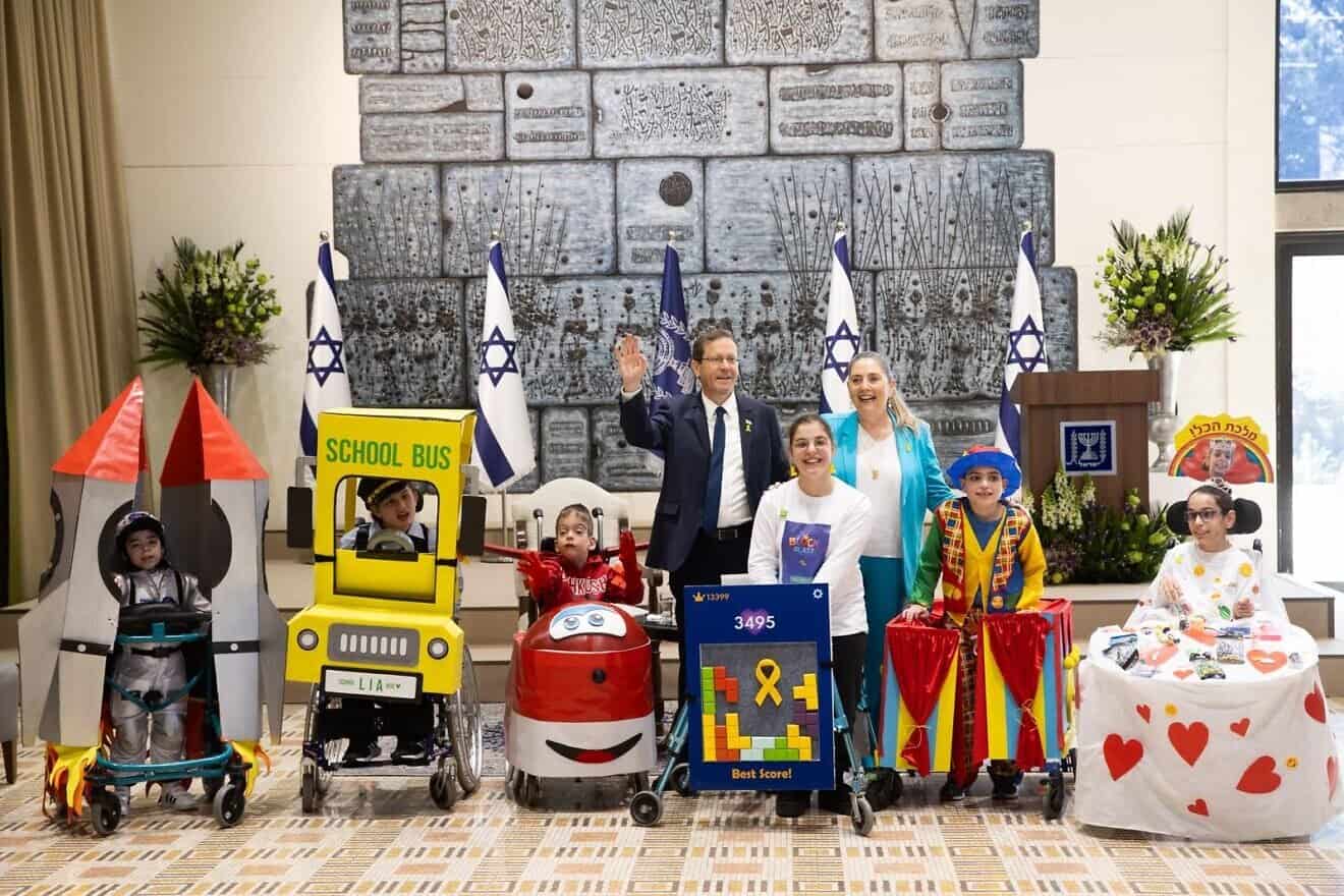 Israeli President Isaac Herzog and his wife, first lady Michal Herzog, host a pre-Purim event for children with special needs at the President's Residence in Jerusalem on March 10, 2025. Photo courtesy of Beit HaNasi.