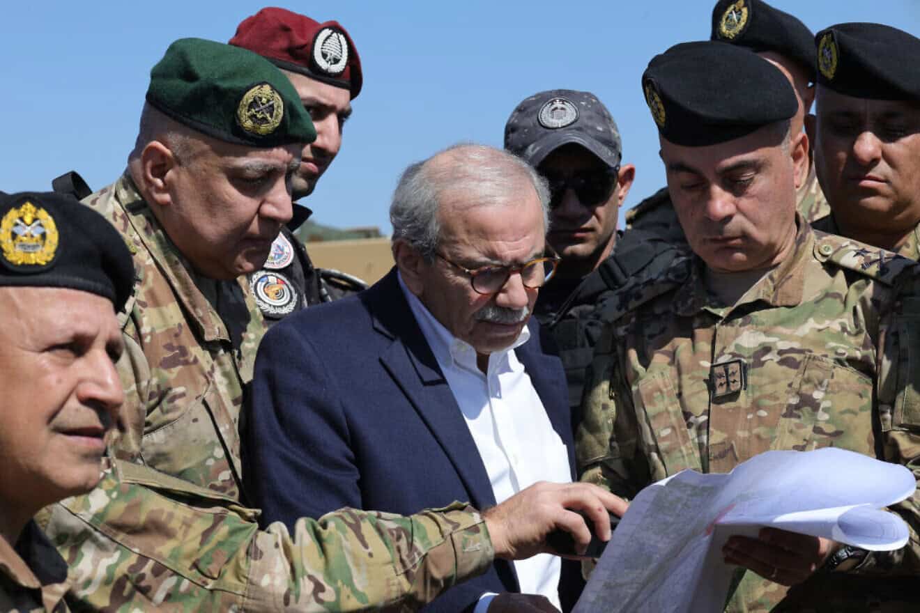 Lebanon's Prime Minister Nawaf Salam checks a map surrounded by Lebanese army soldiers as he visits Khiam, a town near the border with Israel, on Feb. 28, 2025. Photo by Rabih Daher/AFP via Getty Images.