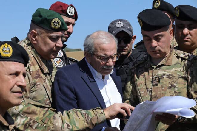 Lebanon's Prime Minister Nawaf Salam checks a map surrounded by Lebanese army soldiers as he visits Khiam, a town near the border with Israel, on Feb. 28, 2025. Photo by Rabih Daher/AFP via Getty Images.