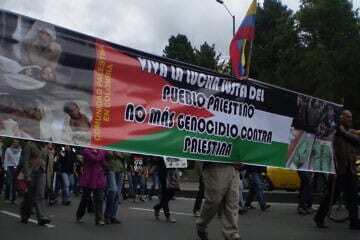 Protestors carry a banner that reads 
