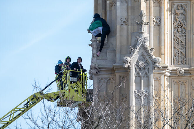 Police use a cherry picker to try to negotiate with a man protesting for “Palestine” on the side of Big Ben in London, on March 8, 2025. Photo by Guy Smallman/Getty Images.